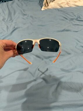 Sunbelt Clear Frame Sunglasses with Orange Temples and Dark Lenses